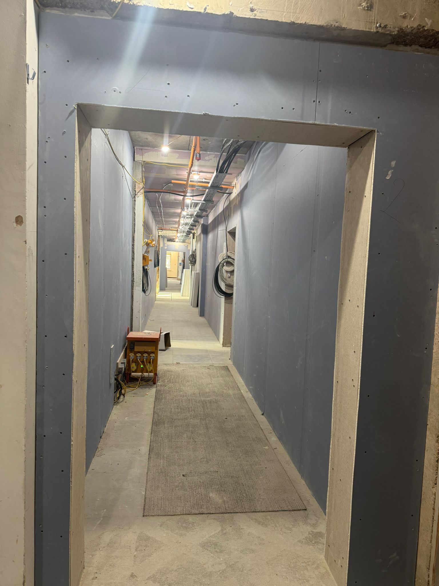 Drylined room with cable risers and finished plasterboard